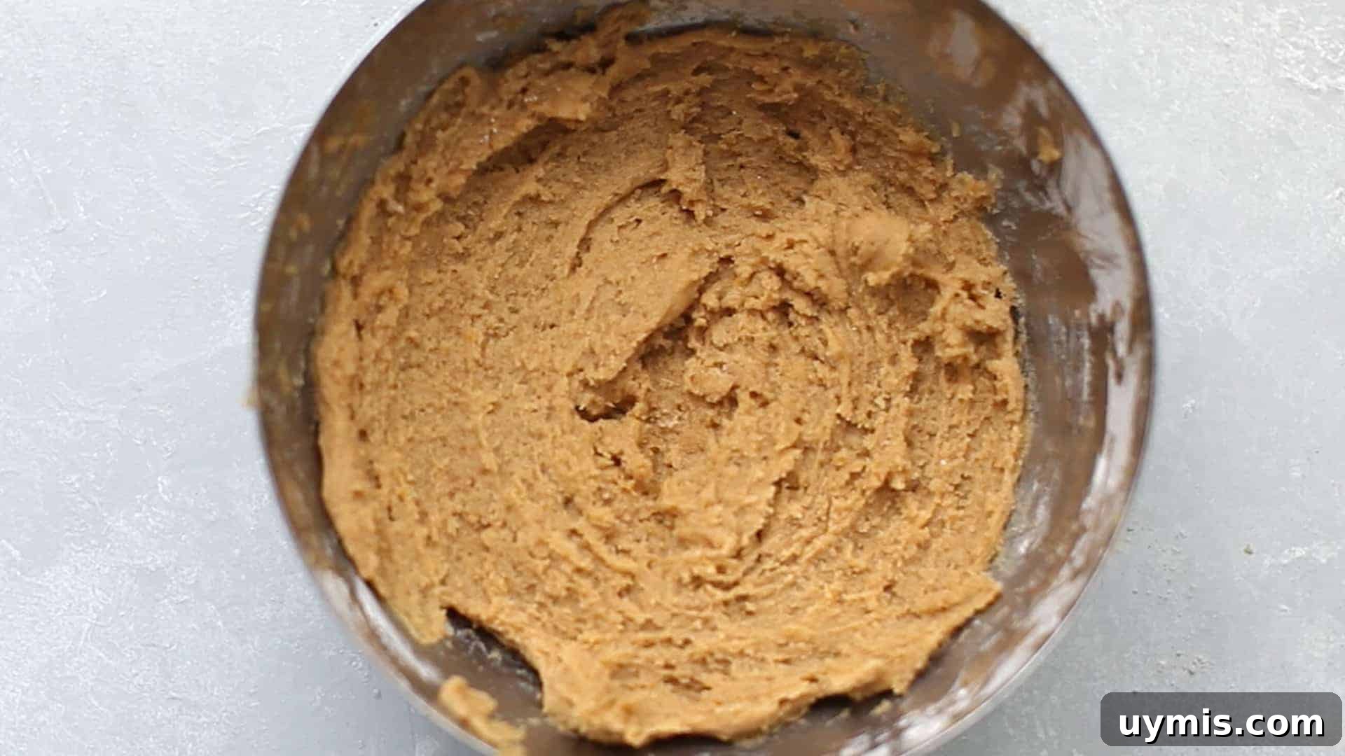 Pumpkin Snickerdoodle Cookies 7 Orange pumpkin snickerdoodle dough in a stainless steel mixing bowl.