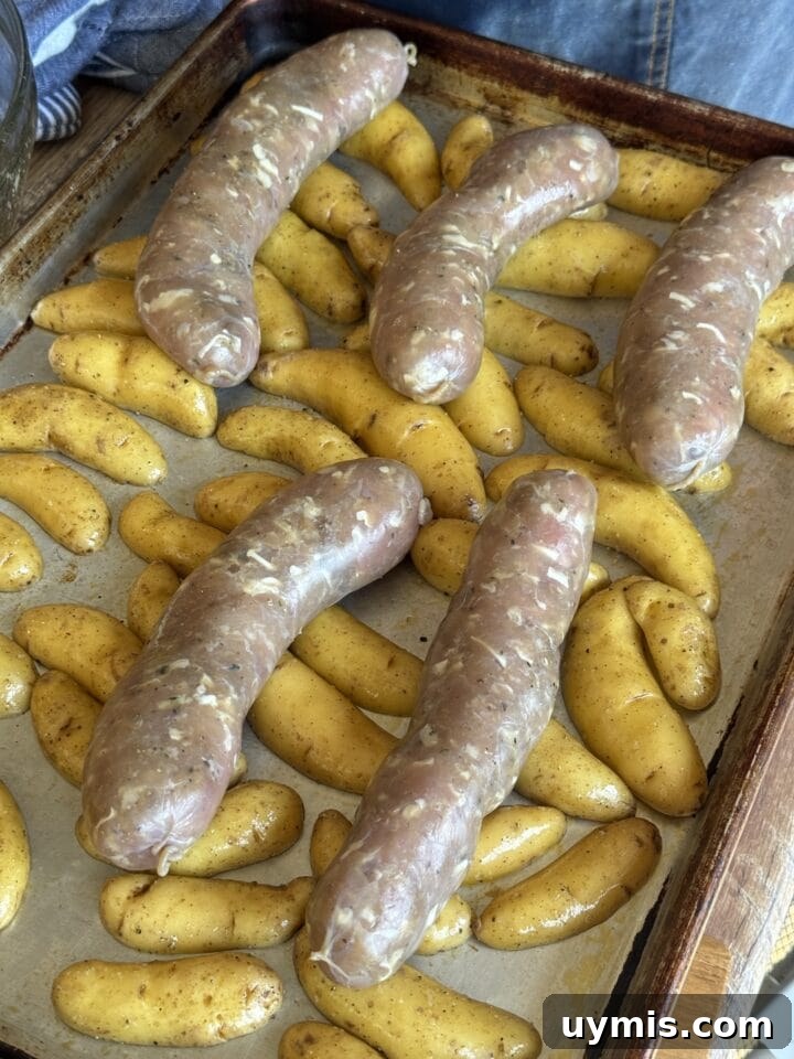 Sheet Pan Sausage and Potatoes Recipe 5 fingerling potatoes and sausage links on a sheet pan