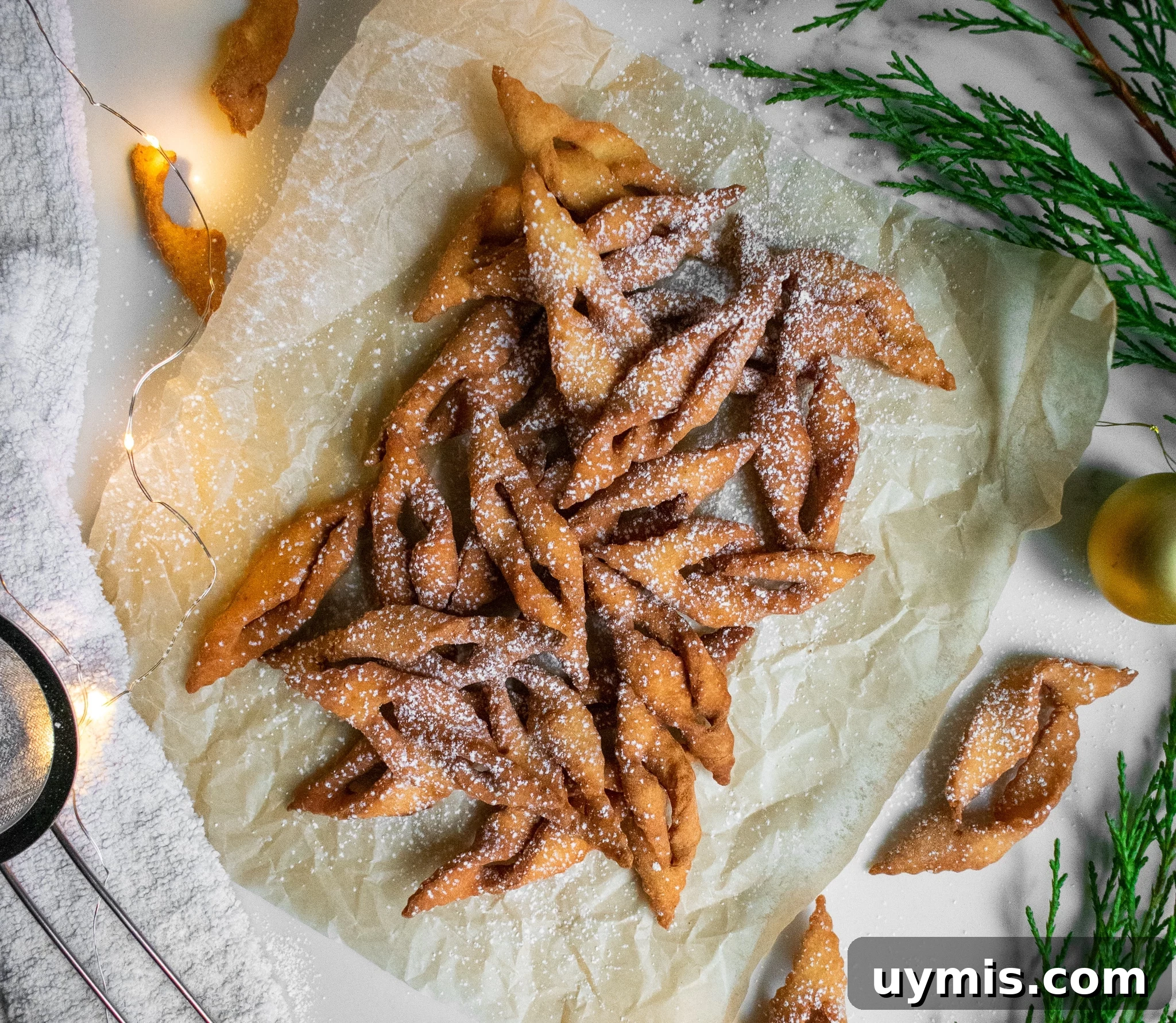 Fried dough cookies on a piece of parchment paper.