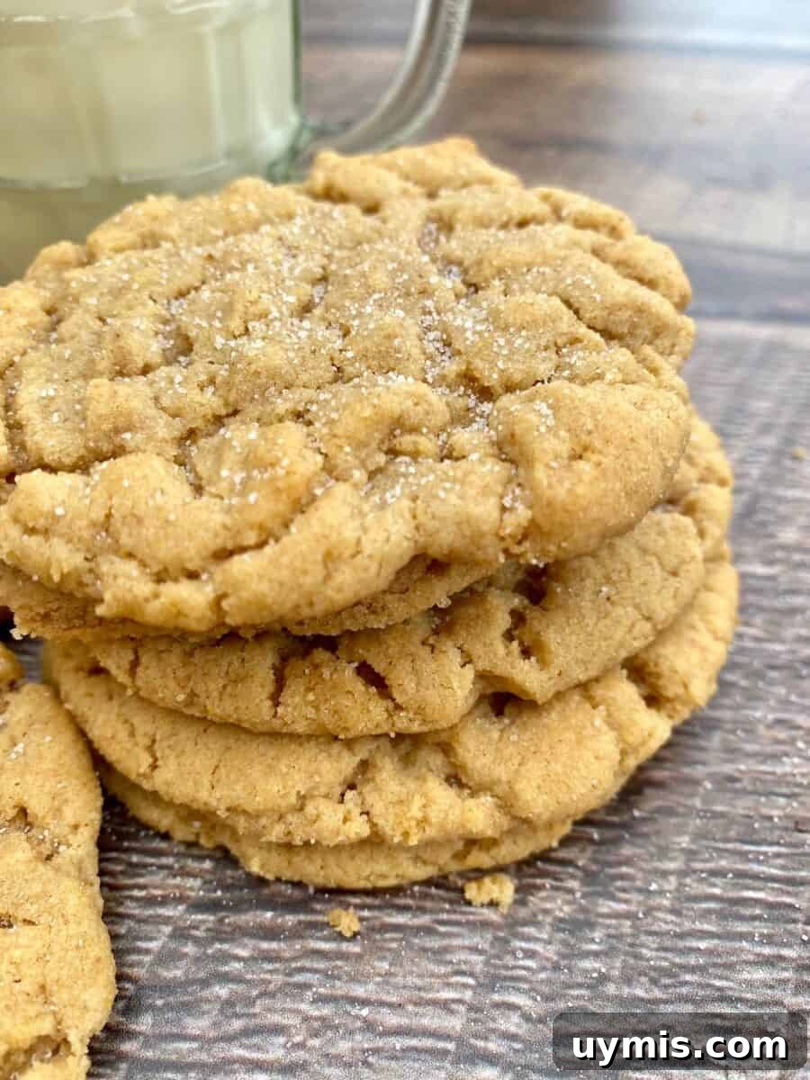 Classic Chewy Peanut Butter Cookies Recipe 2 A stack of peanut butter cookies next to a glass of milk.