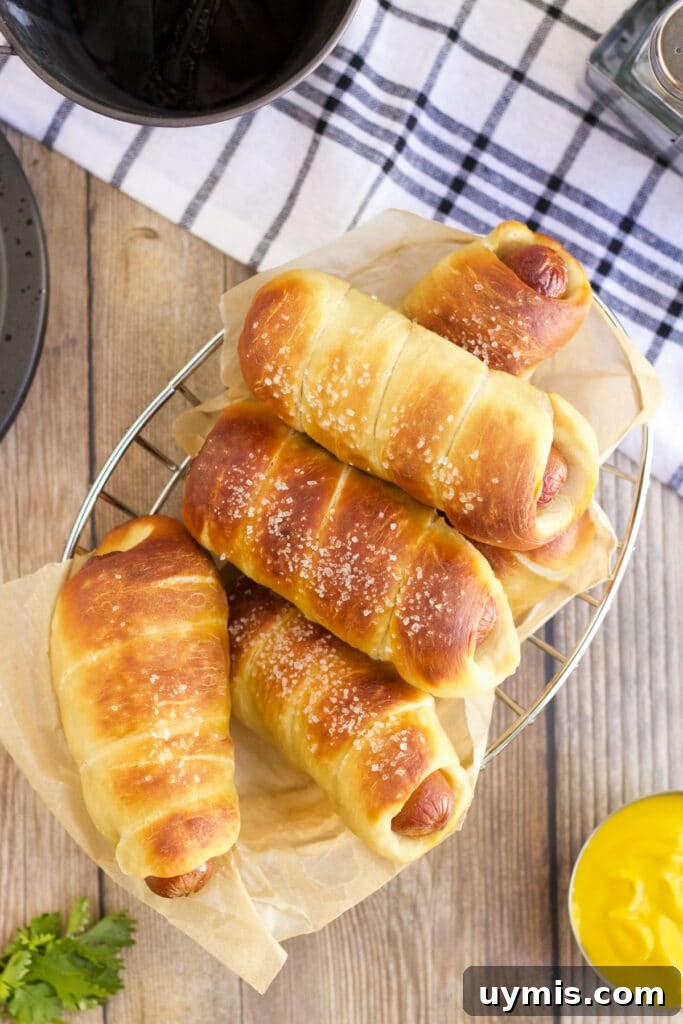 Pretzel Dogs Recipe: Soft Pretzel-Wrapped Hot Dogs 7 Finished pretzel dogs on a plate