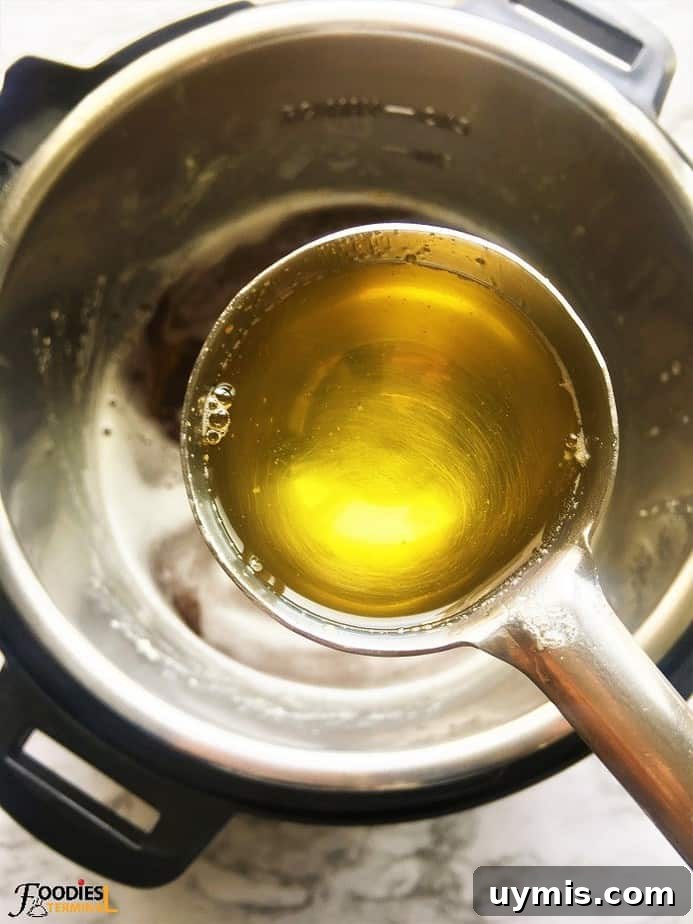 Instant Pot Ghee Recipe: Homemade Clarified Butter 11 Instant pot golden ghee ready in a ladle