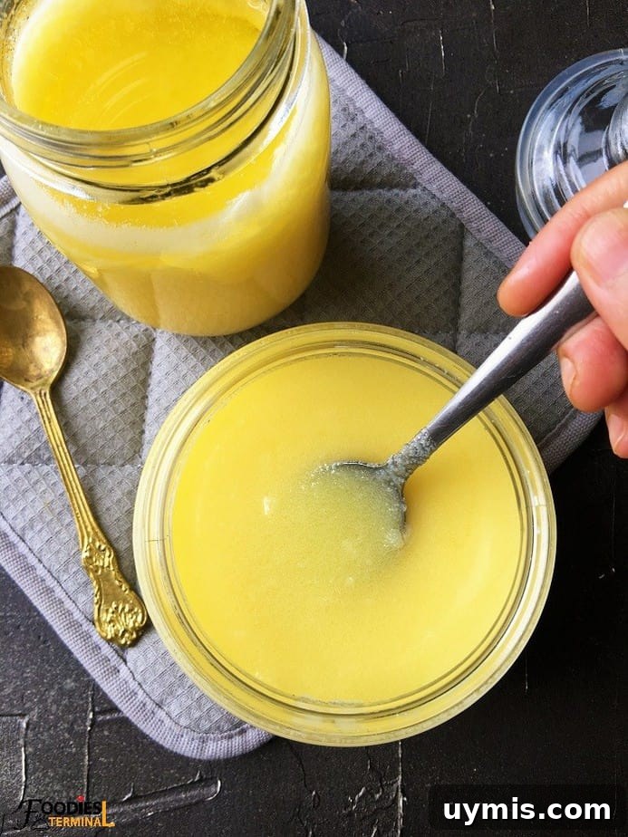 Instant Pot Ghee Recipe: Homemade Clarified Butter 3 homemade ghee in semi solid state in two glass jars with spoon