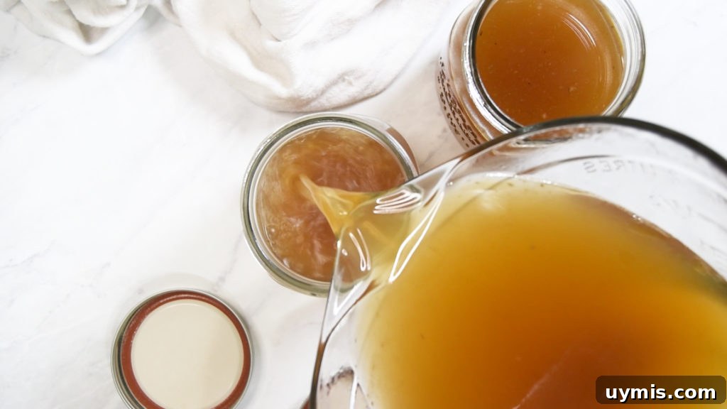 How to Make Instant Pot Turkey Stock 8 A pitcher pours stock into a mason jar