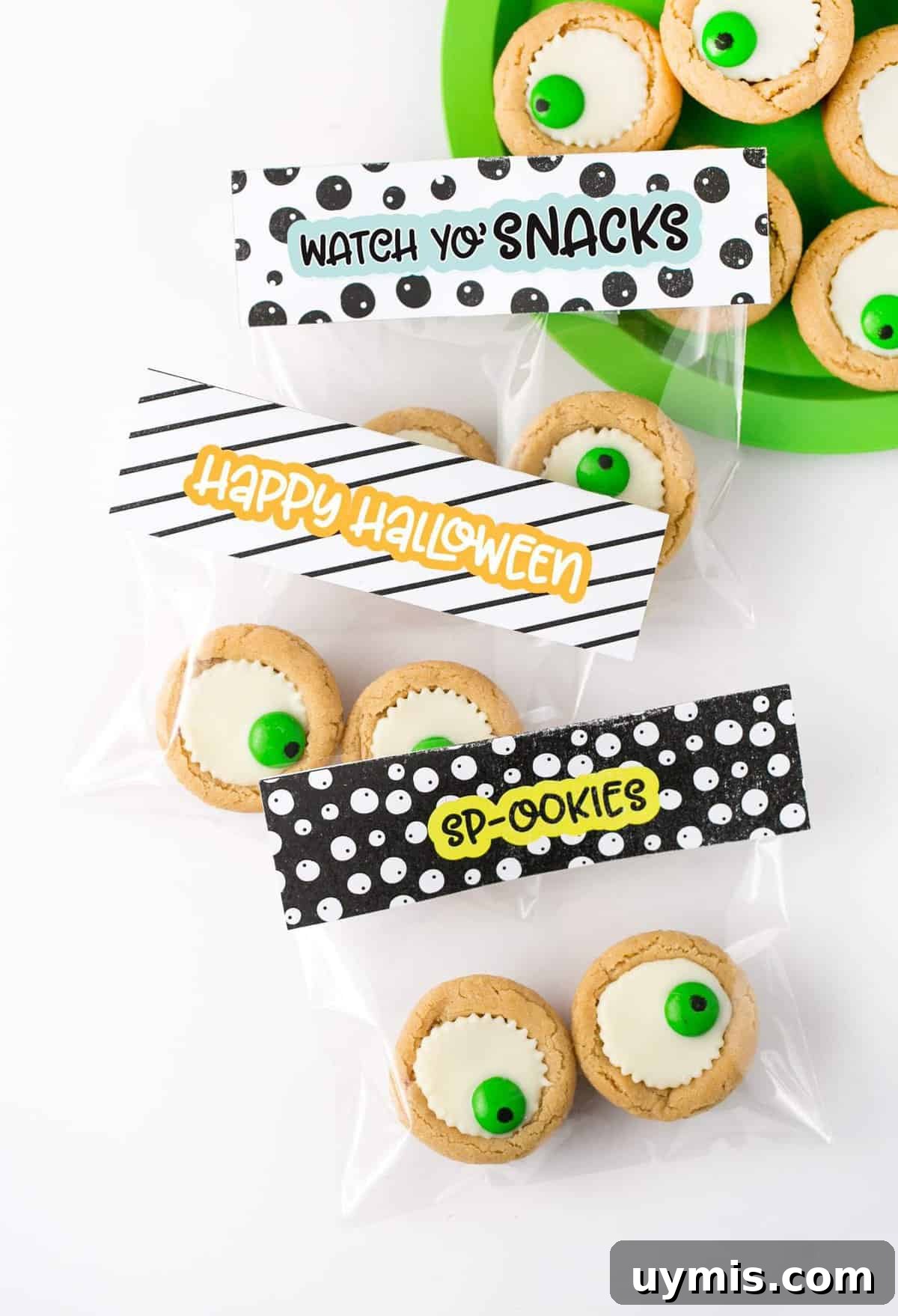Halloween Eyeball Cookies with Peanut Butter Cups 12 Easy Halloween Eyeball Cookies the kids can help with! After baking, simply press a miniature white peanut butter cup and M&M into the top of each one for a spooky (but cute!) halloween cookie idea. #Halloween #Cookies #EyeballCookies | www.DesignEatRepeat.com