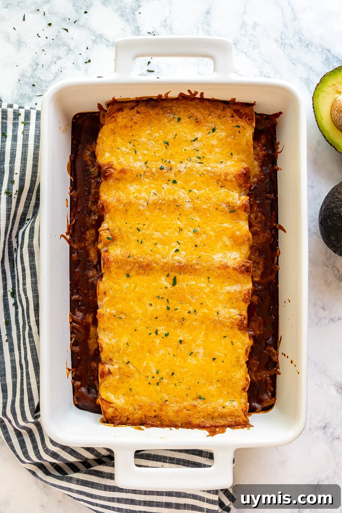 An overhead image of a pan of chicken enchiladas.