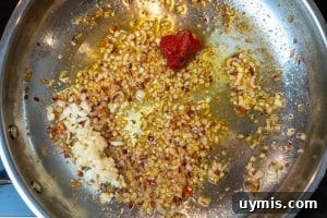 Adding the garlic & tomato paste
