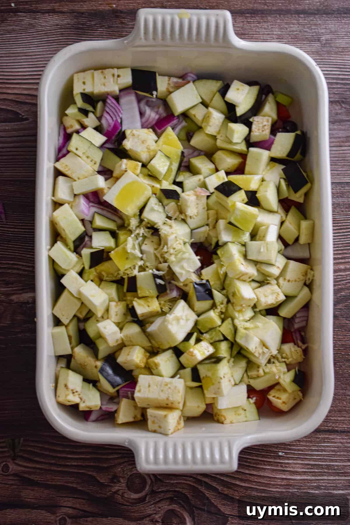 Creamy Greek Baked Pasta with Feta 4 The vegetables are diced and added to a casserole dish.