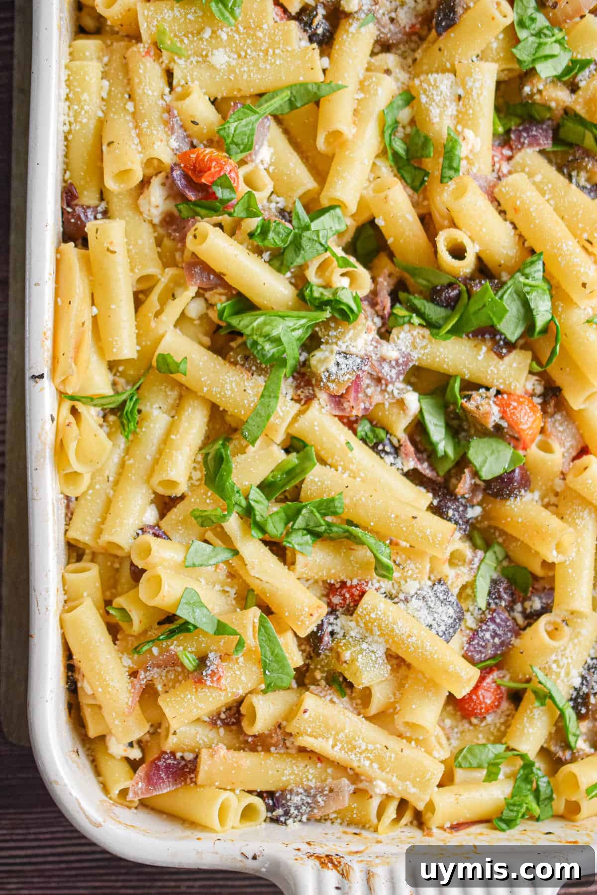 Creamy Greek Baked Pasta with Feta 10 Fresh herbs are topping the Greek Pasta Bake in the bakign dish.