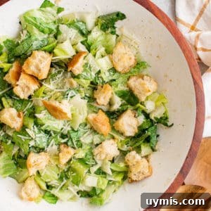 Close up view of Caesar Salad in a white bowl.