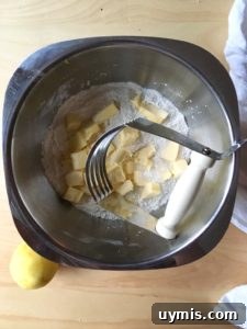 Lemon Cream Scones Recipe with Edible Flowers 2 Three lemon cream scones on a plate