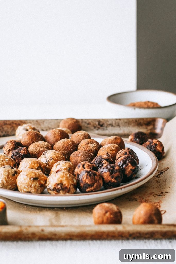 Bliss Balls Recipe 3 Ways 4 raw energy balls on a plate on a baking tray