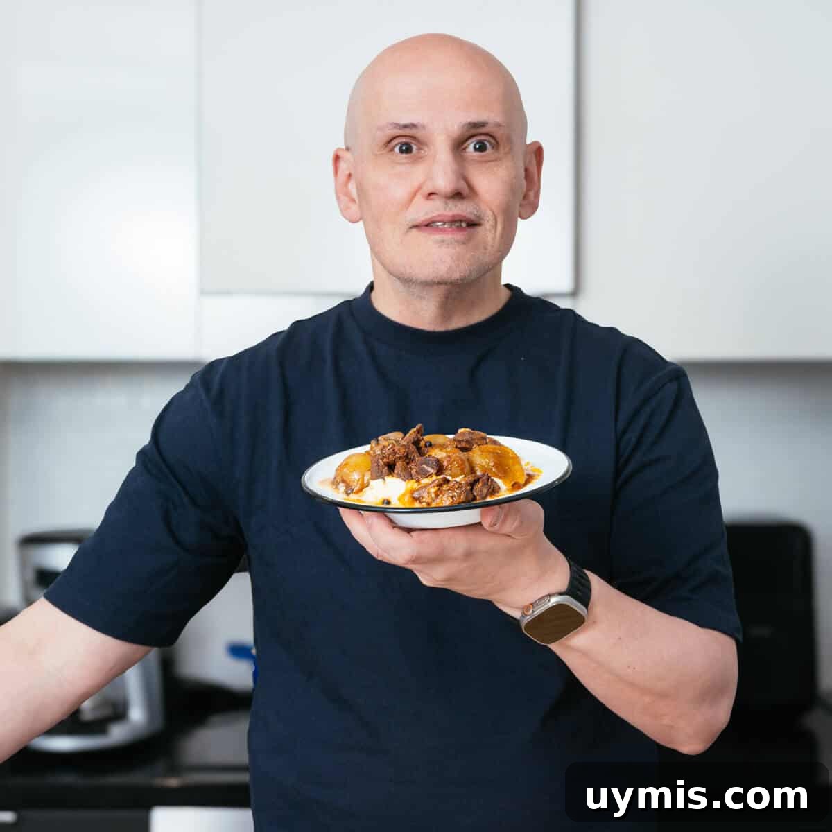 Greek Beef Stifado Recipe: Classic Slow-Braised Stew 3 Blogger Peter G holding his finished dish of beef stifado.