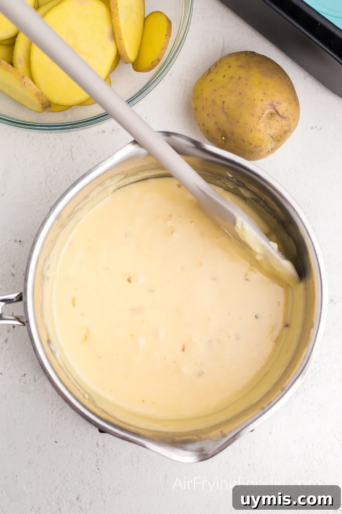 Air Fryer Scalloped Potatoes with Melted Cheese 6 Queso, cream cheese, and butter melted together in a small pan.