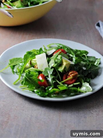 Arugula avocado salad on a small plate