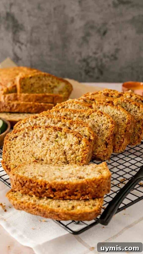Moist Banana Zucchini Bread Recipe 2 Sliced banana zucchini bread loaf on a wire cooling rack.