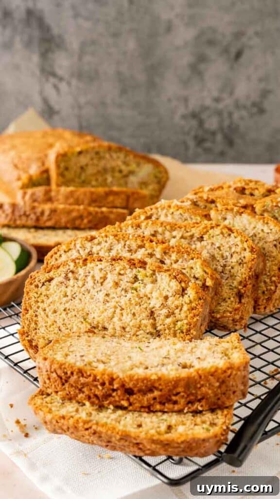 Moist Banana Zucchini Bread Recipe 7 Thickly sliced banana zucchini bread with a sliced loaf in the background.