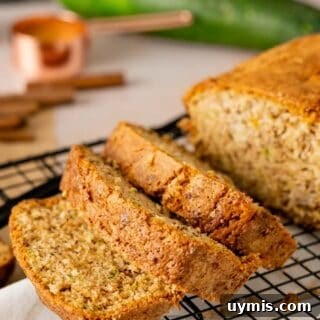 Moist Banana Zucchini Bread Recipe 8 Sliced banana zucchini bread on a square black cooling rack.