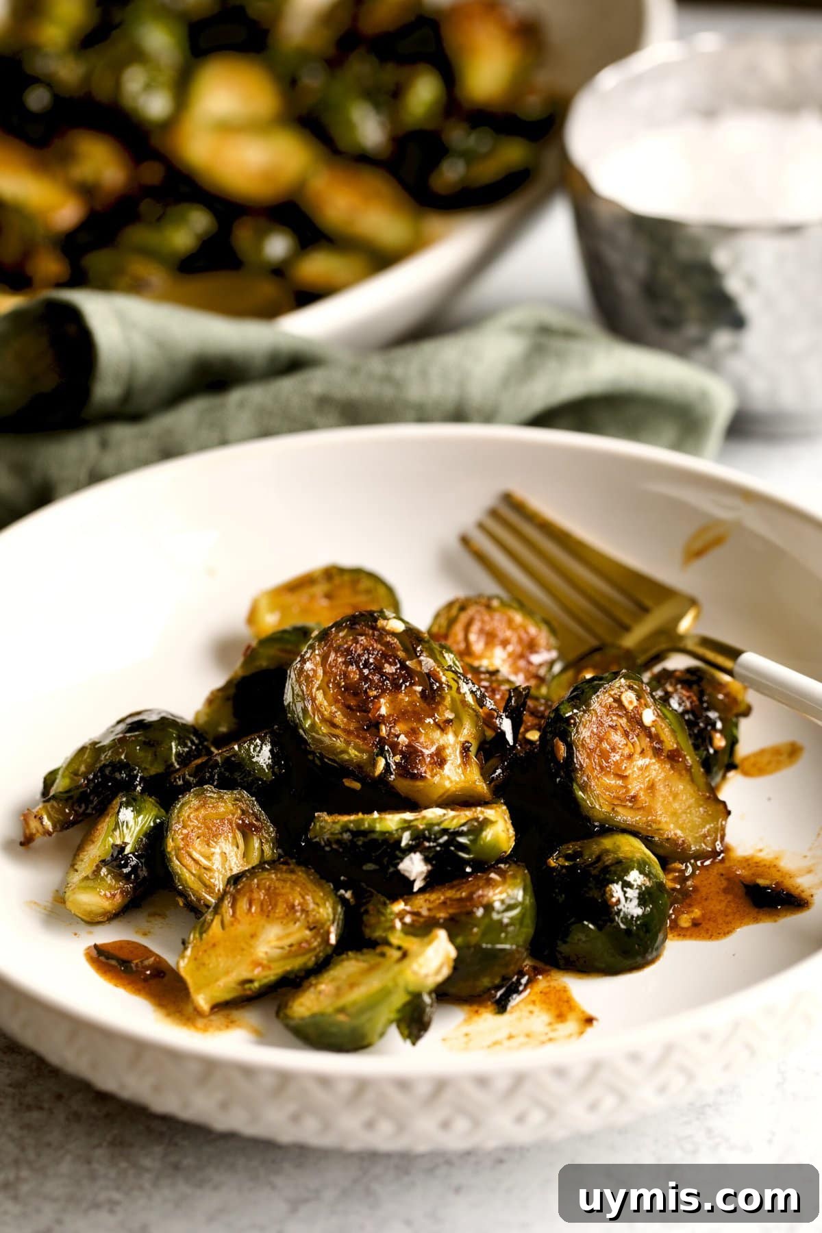 LongHorn Steakhouse Copycat Crispy Brussels Sprouts Recipe 3 Copycat Longhorn Steakhouse crispy brussels sprouts on a plate with a fork.