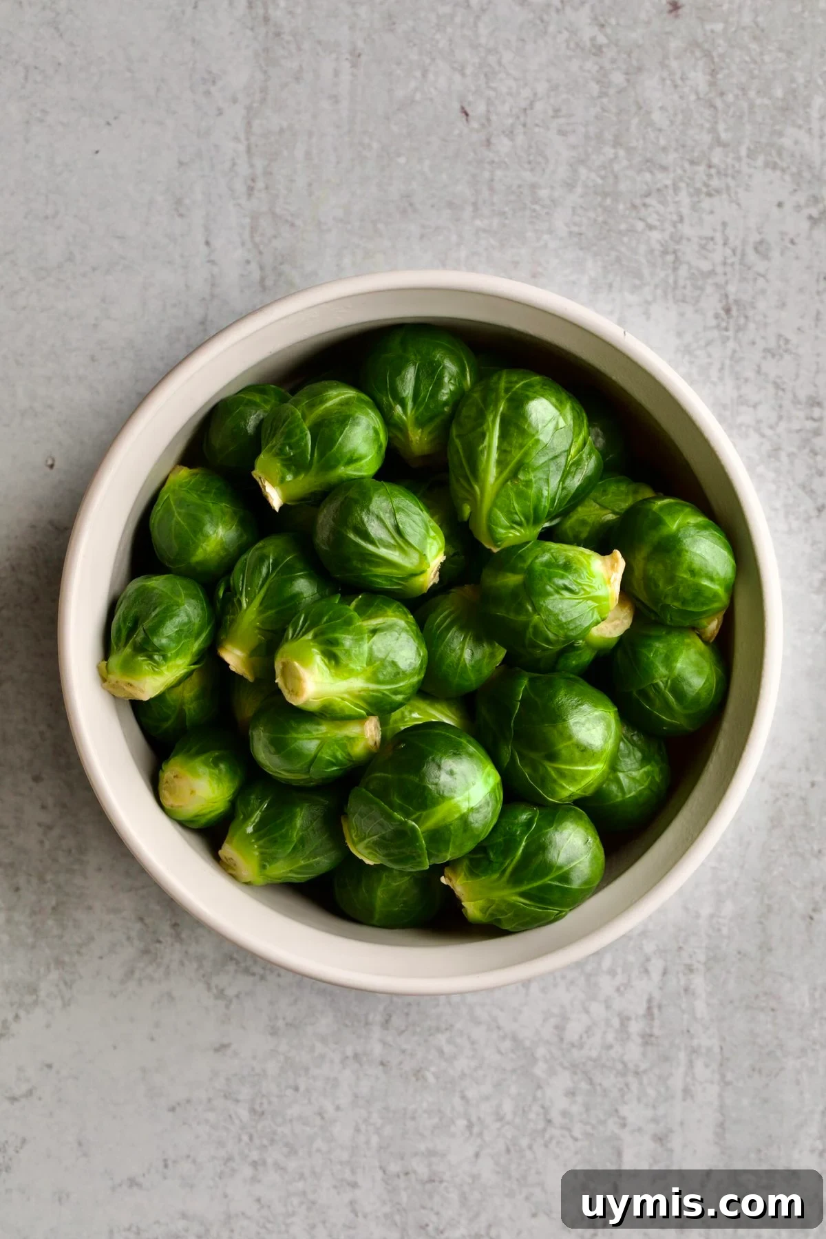 LongHorn Steakhouse Copycat Crispy Brussels Sprouts Recipe 6 White bowl of whole brussels sprouts.