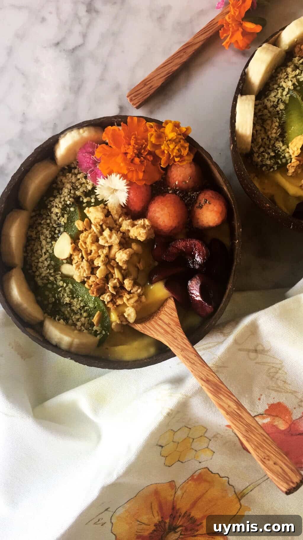 Mango Breakfast Smoothie Bowl Recipe 2 Delicious and healthy smoothie bowl topped with raspberries, kiwi, bananas, chia seeds, granola, and hemp seeds