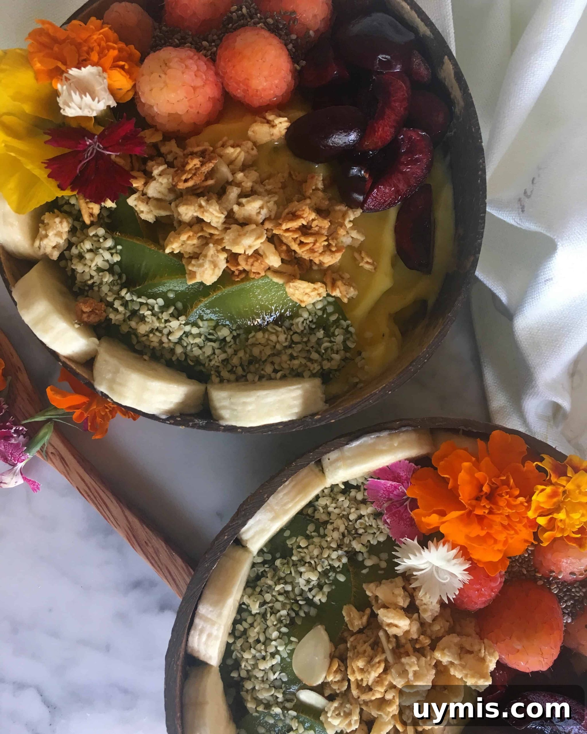 Mango Breakfast Smoothie Bowl Recipe 5 The final product of our healthy smoothie bowls. Topped with cherries, kiwi, banana, raspberry, chia seeds, granola and hemp seeds