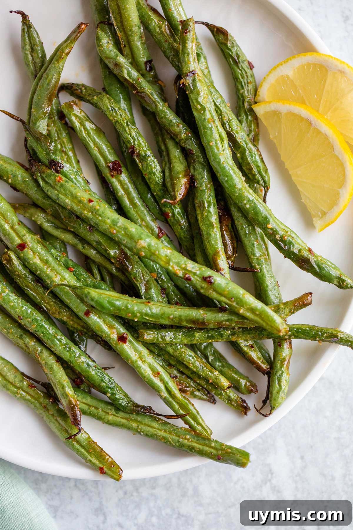 Crispy Spicy Air Fryer Green Beans 2 Spicy green beans on a white plate