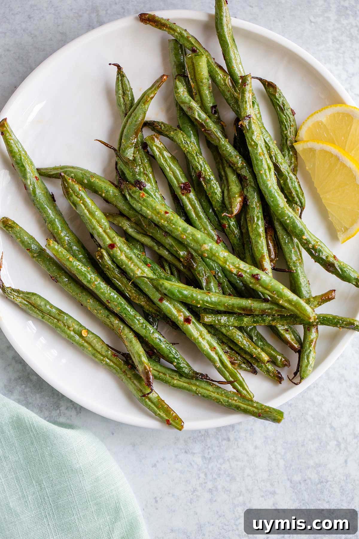 Crispy Spicy Air Fryer Green Beans 8 Air fryer spicy green beans on a white plate