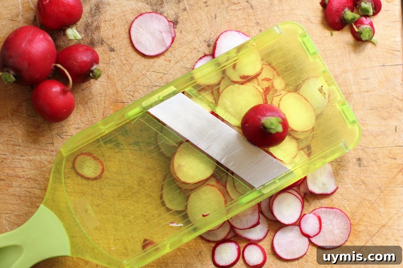 Spring Chive and Egg Pasta Salad Recipe 10 Slicing radishes on a mandoline for the Chive & Egg Pasta Salad
