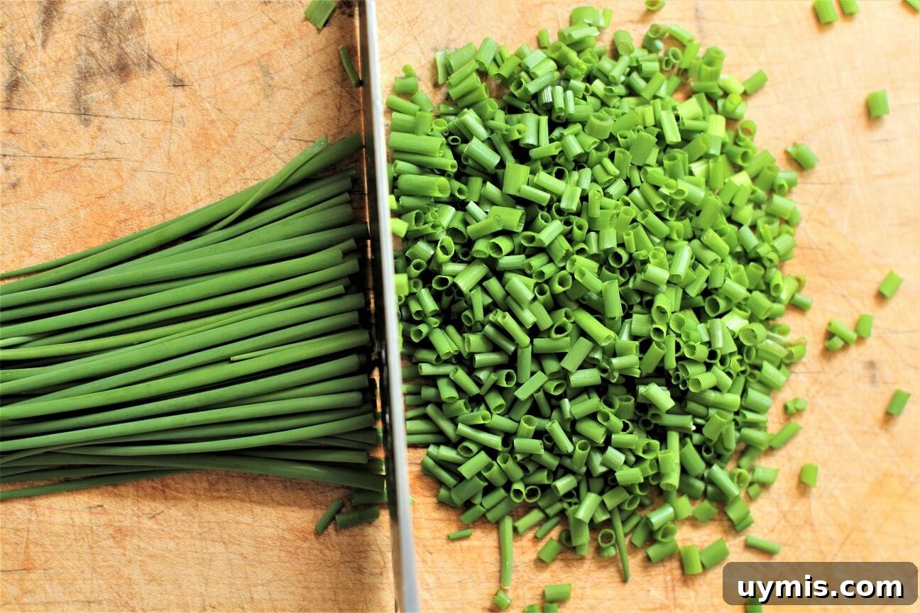 Spring Chive and Egg Pasta Salad Recipe 9 Chopping fresh chives on cutting board for the Chive & Egg Pasta Salad