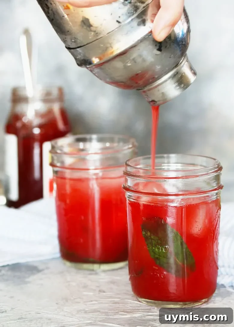 Strawberry Jam Cocktail with Fresh Mint 3 mint strawberry jam cocktail being poured from a cocktail shaker