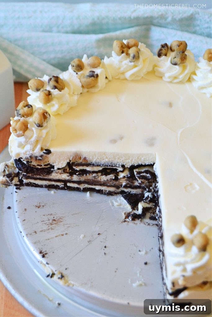 No-Bake Oreo Icebox Cake with Chocolate Chip Cookie Dough 5 cookie dough oreo icebox cake in the pan with a giant slice cut out