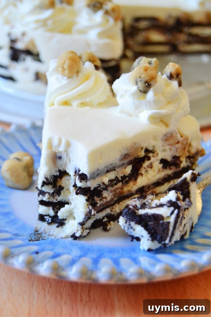 No-Bake Oreo Icebox Cake with Chocolate Chip Cookie Dough 7 closeup slice of cookie dough oreo icebox cake with bite missing on blue plate