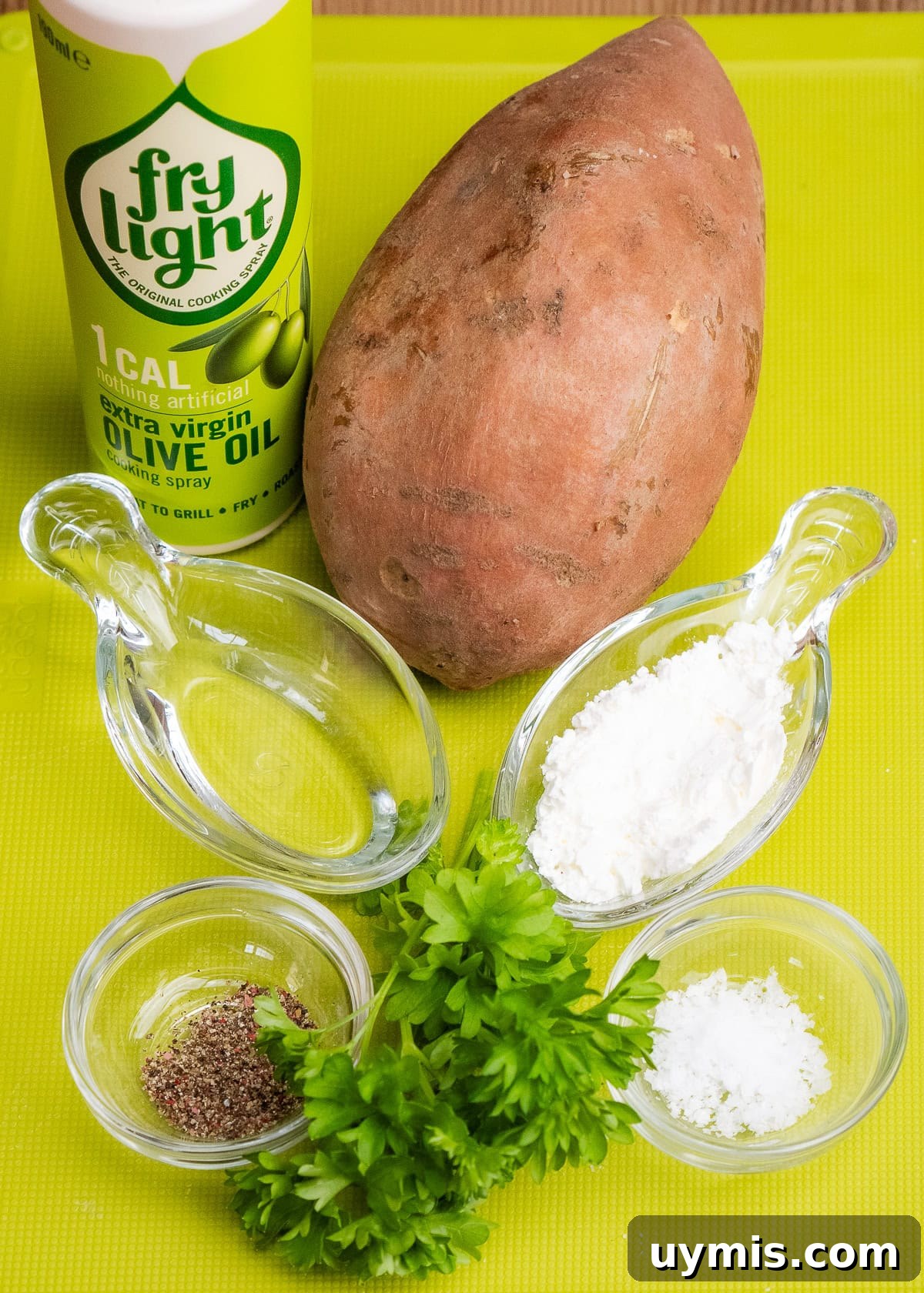 Crispy Air Fryer Sweet Potato Fries 15 Fry light olive oil, one sweet potato, cornflour, salt , black pepper, water and sprigs of fresh parsley on a green chopping board