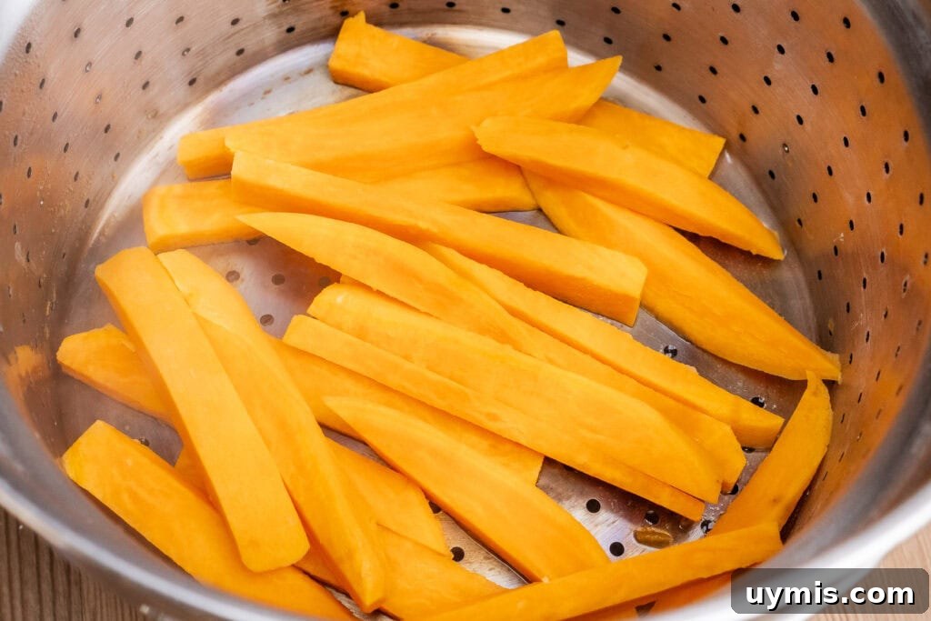 Crispy Air Fryer Sweet Potato Fries 24 Sweet Potato Fries in a drainer