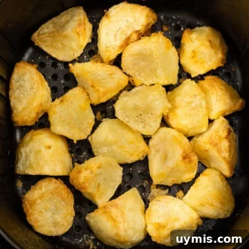Golden and crispy roast potatoes cooked in the air fryer.