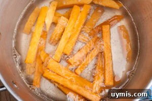 Crispy Air Fryer Sweet Potato Fries 6 Boiling sweet potato fries in a large pot