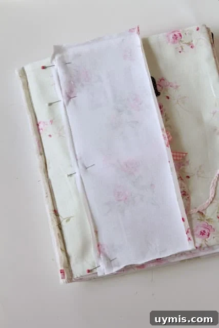 Quiet Book Sew Along Part 9 Finishing Your Book 8 Binding fabric pinned to the front cover of a quiet book