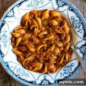 Pasta e Lenticchie Italian Pasta and Lentils Recipe 7 Pasta and lentils in a blue and white vintage bowl sitting on a wooden surface.