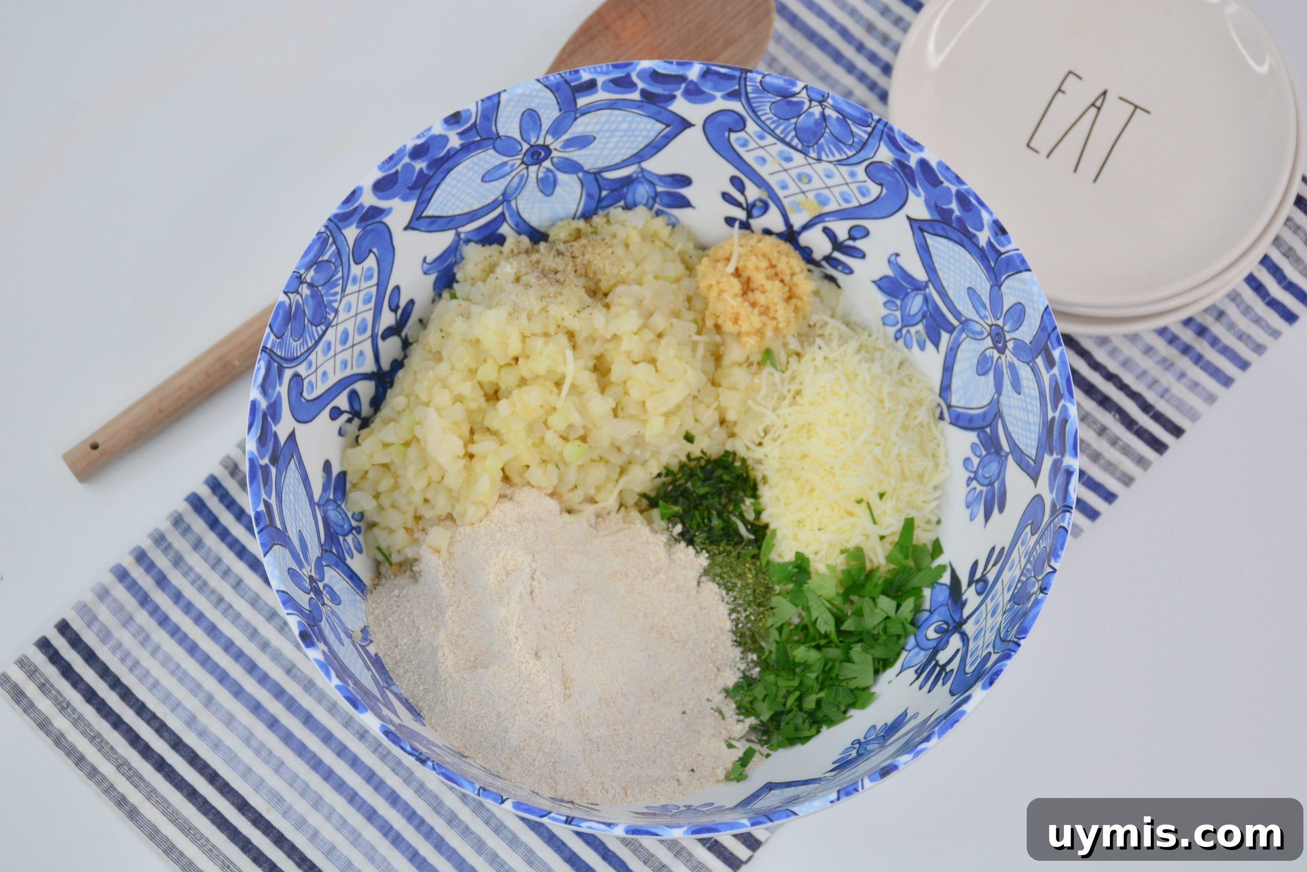 Ingredients for cauliflower fritters in a mixing bowl