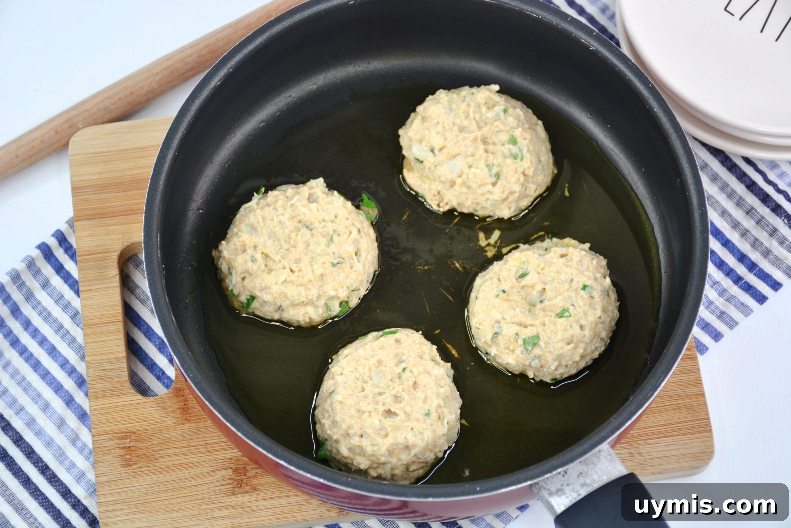 Flattened cauliflower fritters in skillet