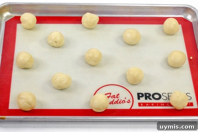 Zesty Orange Juice Cookie Recipe with Citrus Glaze 5 balls of cookie batter on baking sheet
