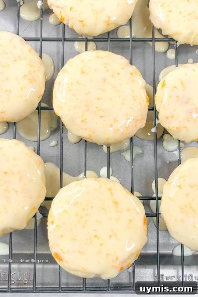 Zesty Orange Juice Cookie Recipe with Citrus Glaze 7 iced orange cookies drying on baking rack