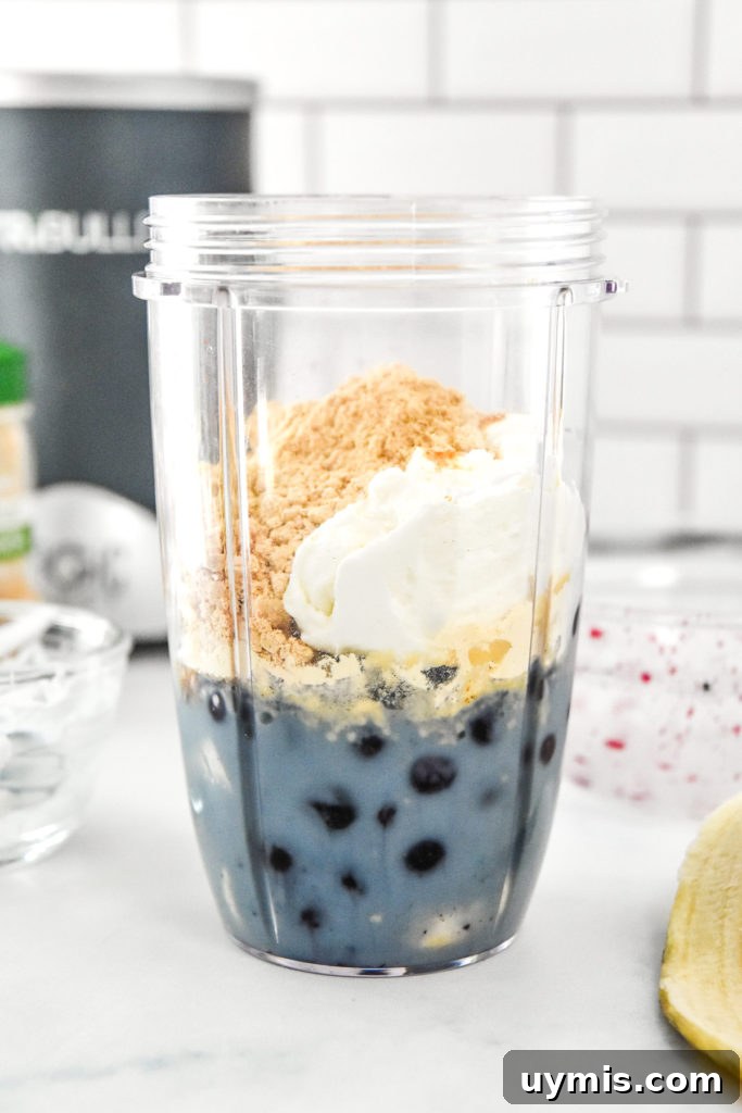 Blueberry Cinnamon Smoothie with Peanut Butter Powder 7 smoothie ingredients in the nutribullet cup before blending.
