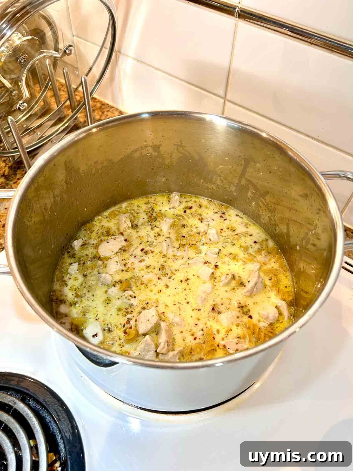 Creamy One Pot Chicken and Broccoli Pasta 5 pasta, chicken broth, and cream added to the pot.