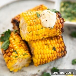 Air fryer corn on the cob served with cream on top.