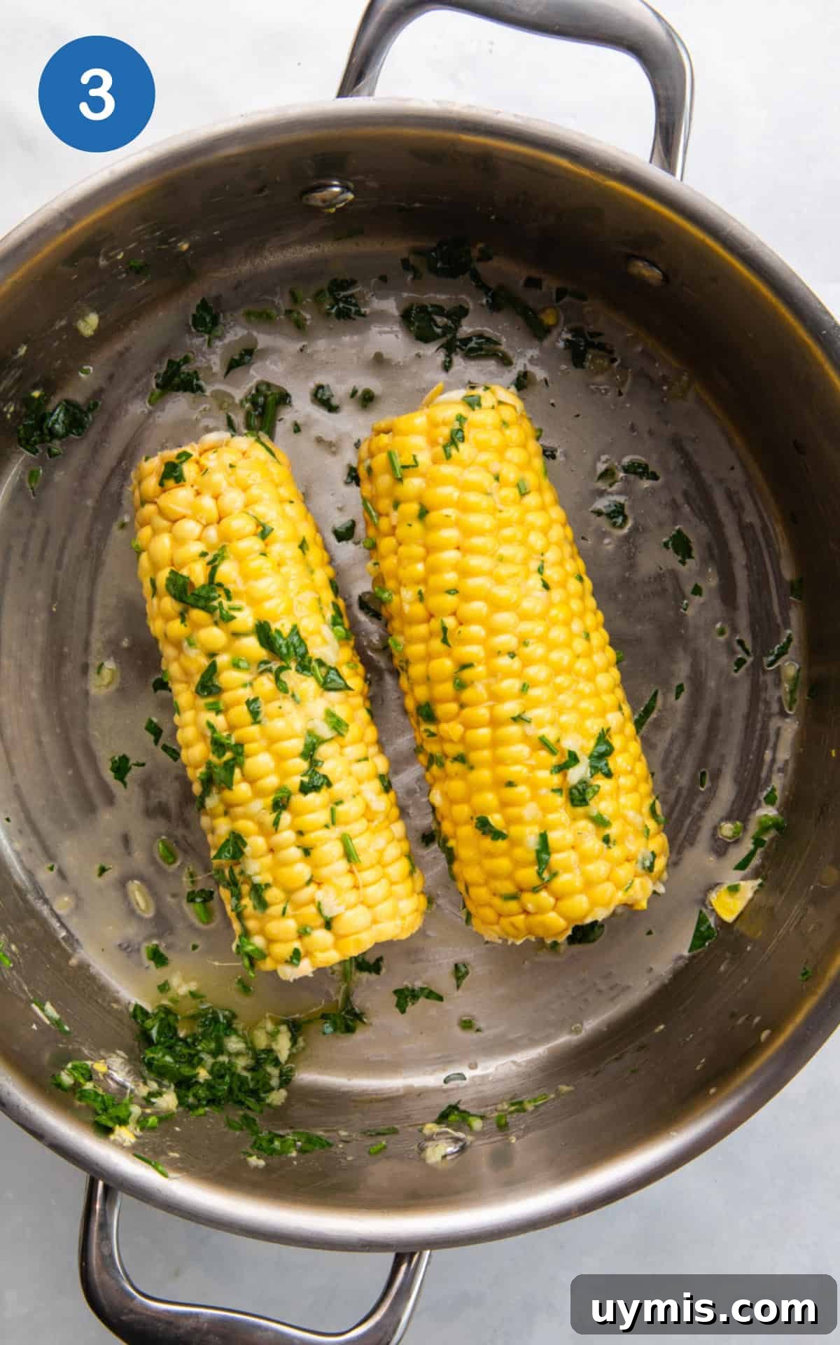 Air Fryer Corn on the Cob Recipe — Juicy and Crispy 6 coating the corn with the sauce.