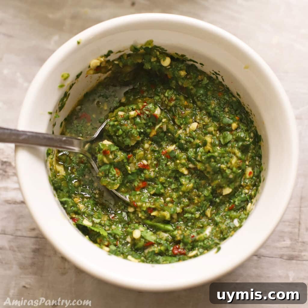 53-Recipe Meal Plan: Weekly Menus and Shopping List 4 A bowl with Zhoug sauce and a spoon in it.