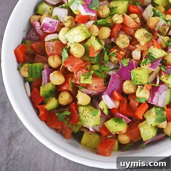 53-Recipe Meal Plan: Weekly Menus and Shopping List 6 Overhead view of a white bowl of chickpea salad.