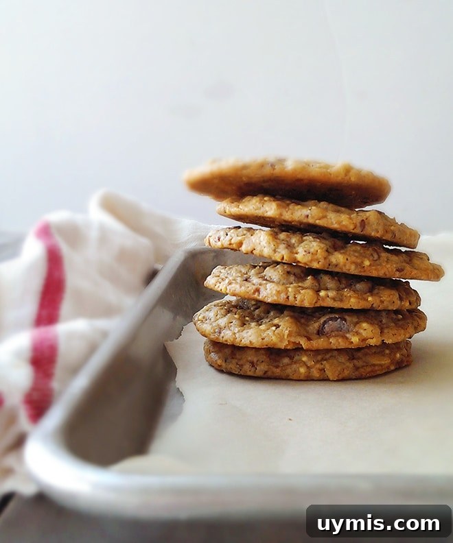 Crispy Oatmeal Cookies Recipe with Brown Sugar Crunch 5 A stack of crunchy oatmeal cookies on a baking sheet.